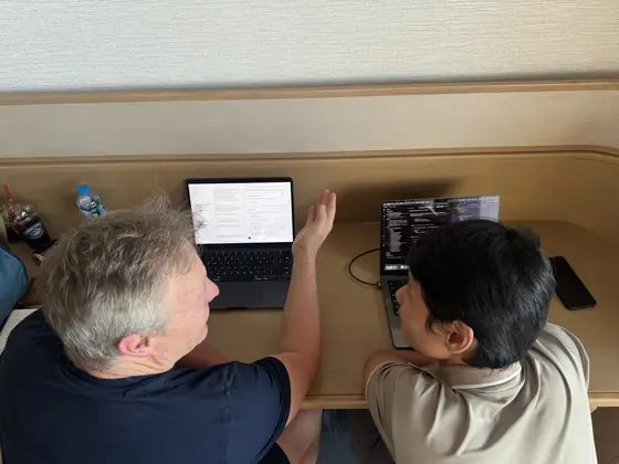 Two Edge8 team members reviewing work on a laptop