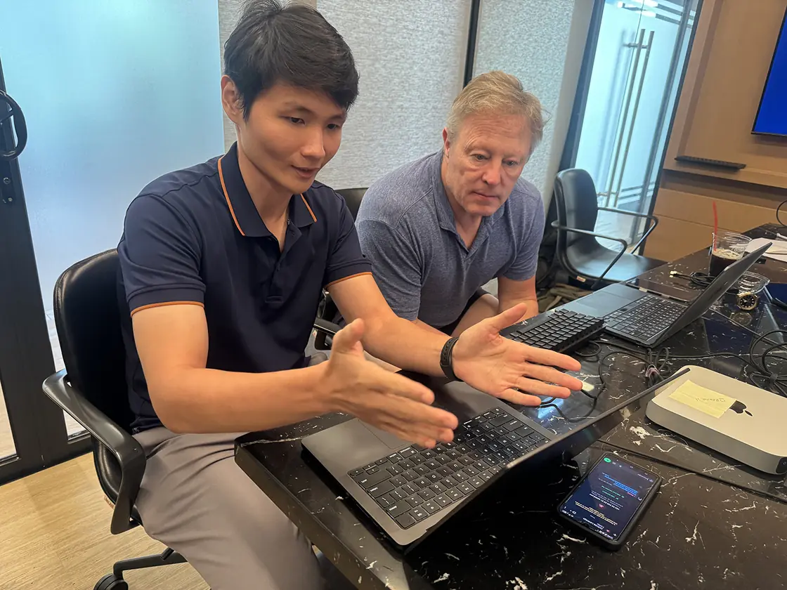 Two Edge8 team members pairing at a desk