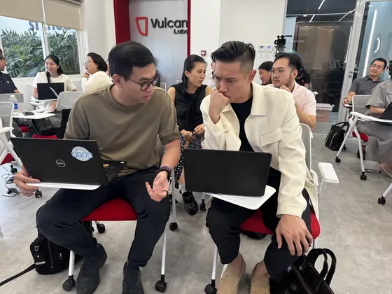 Two Edge8 team members working side by side